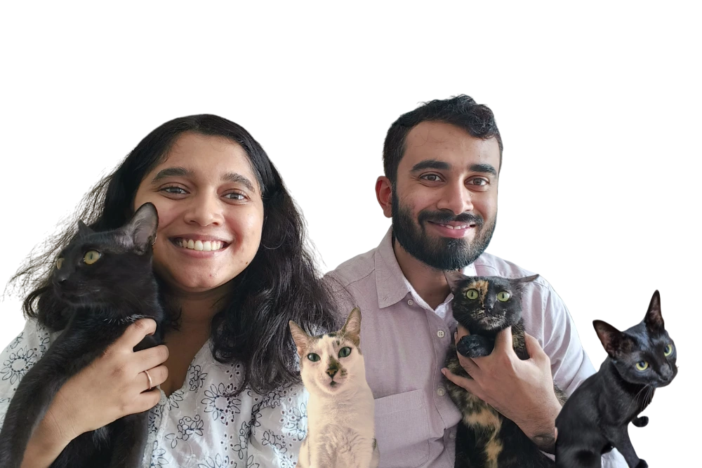 Divya, Alwin, and their four cats posing for a candid family photo.