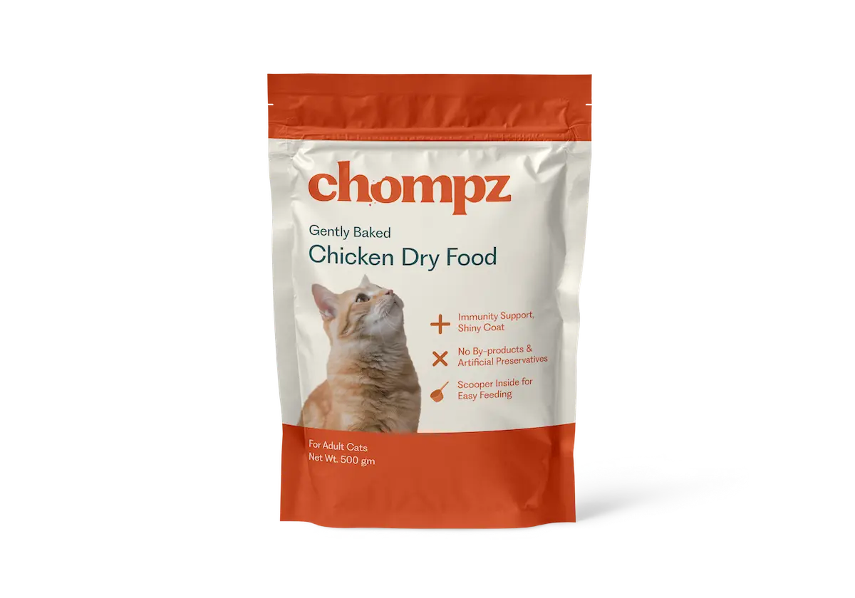 Bag of Baked Chicken Dry Food for pets, labeled with the brand name, displayed on a light peach background.